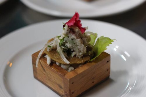 Smoked fish salad served on puffed-popped riceflour cracker 